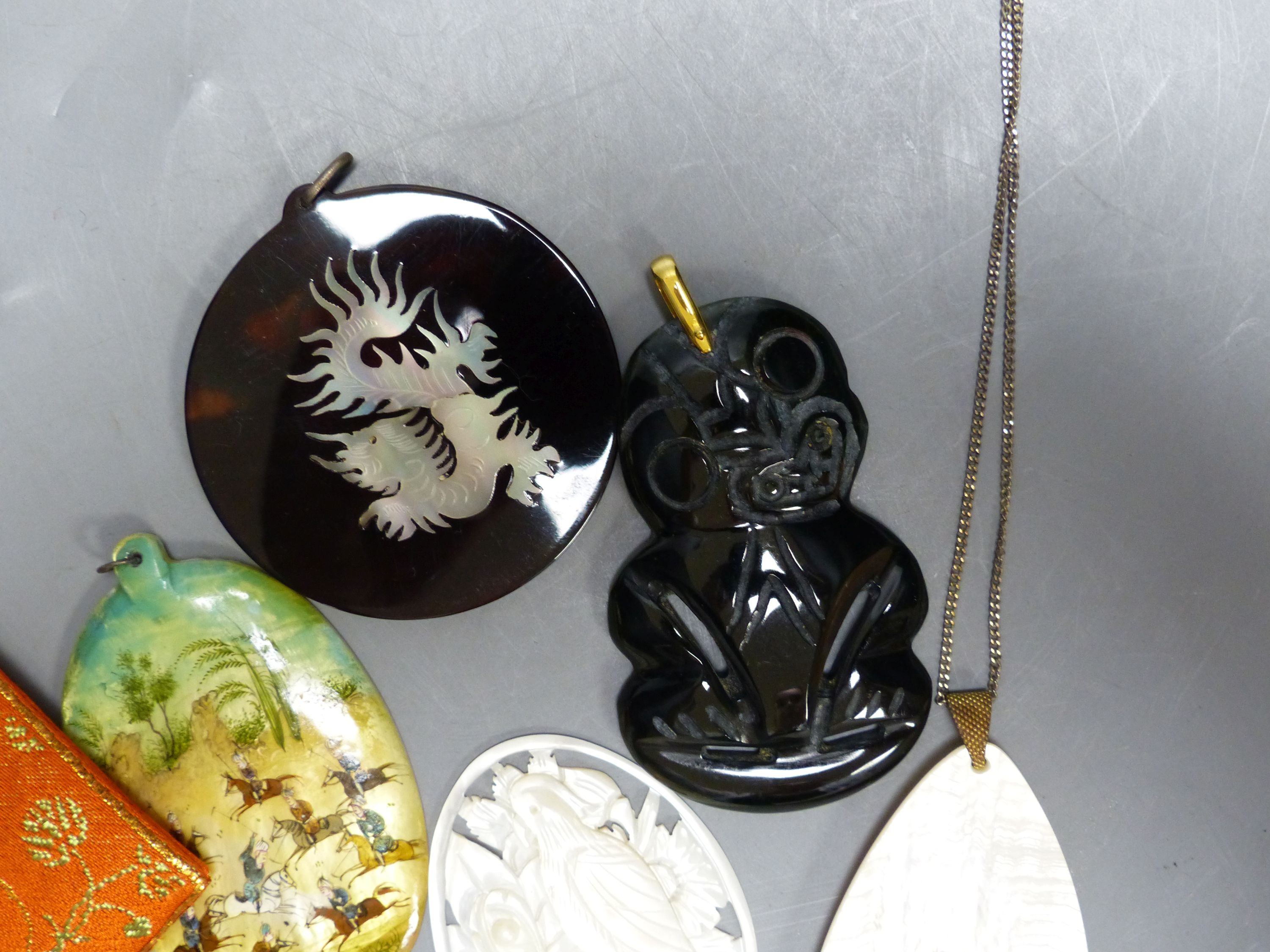 Miscellaneous decorative items, including a Mughal oval miniature on mother of pearl of polo players, a black painted hardstone tiki